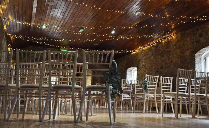 Wedding ceremony chiavari chairs with festoon ceiling string lights, wedding chair hire