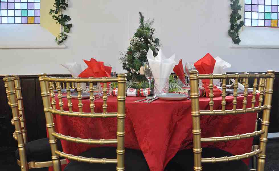 Gold chiavari chairs with tables for hire with red linen, party hire tables