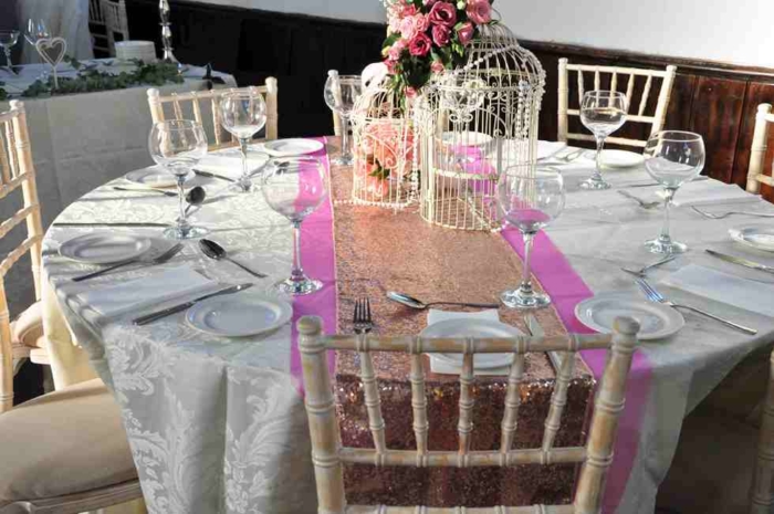 Round table with rose sequin table runner, chair and tables for party hire